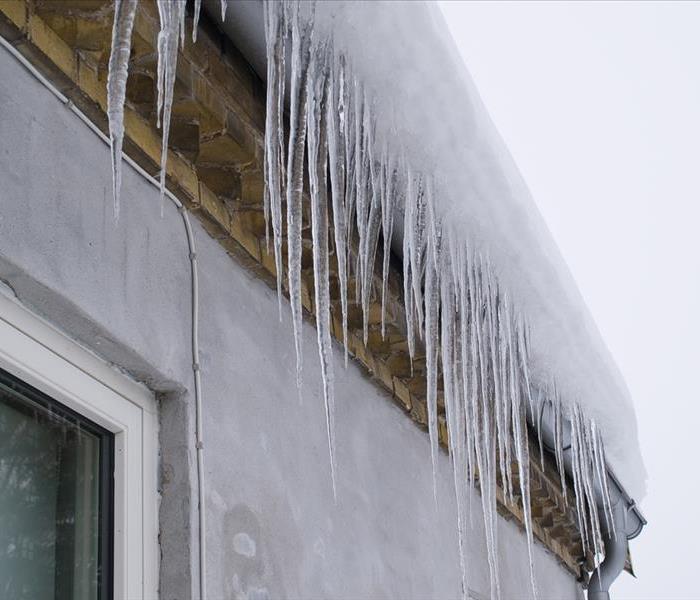 Icicles on a roof winter background image
