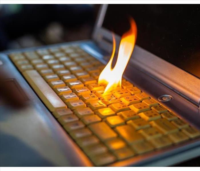 Fire flame coming out of a keyboard of a computer